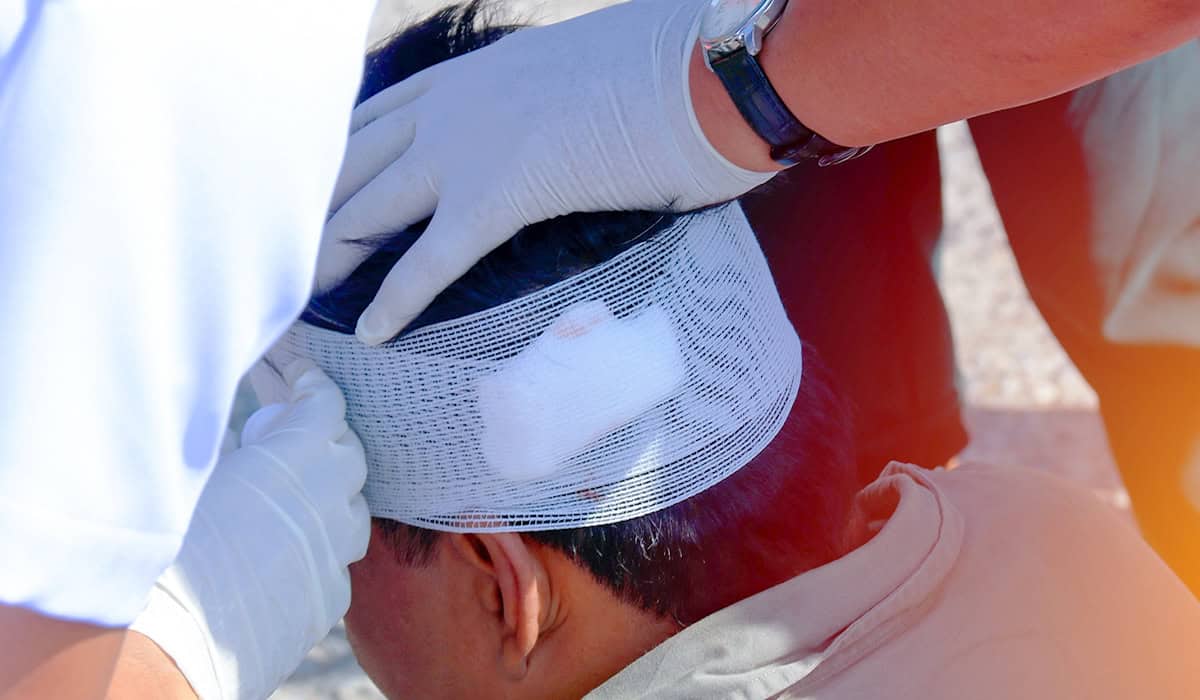 An image of a bandage being wrapped around a patient's head