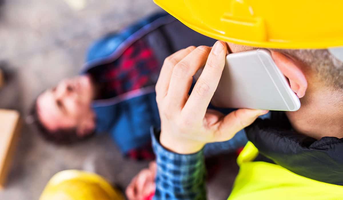 An image of someone phoning for help after an accident