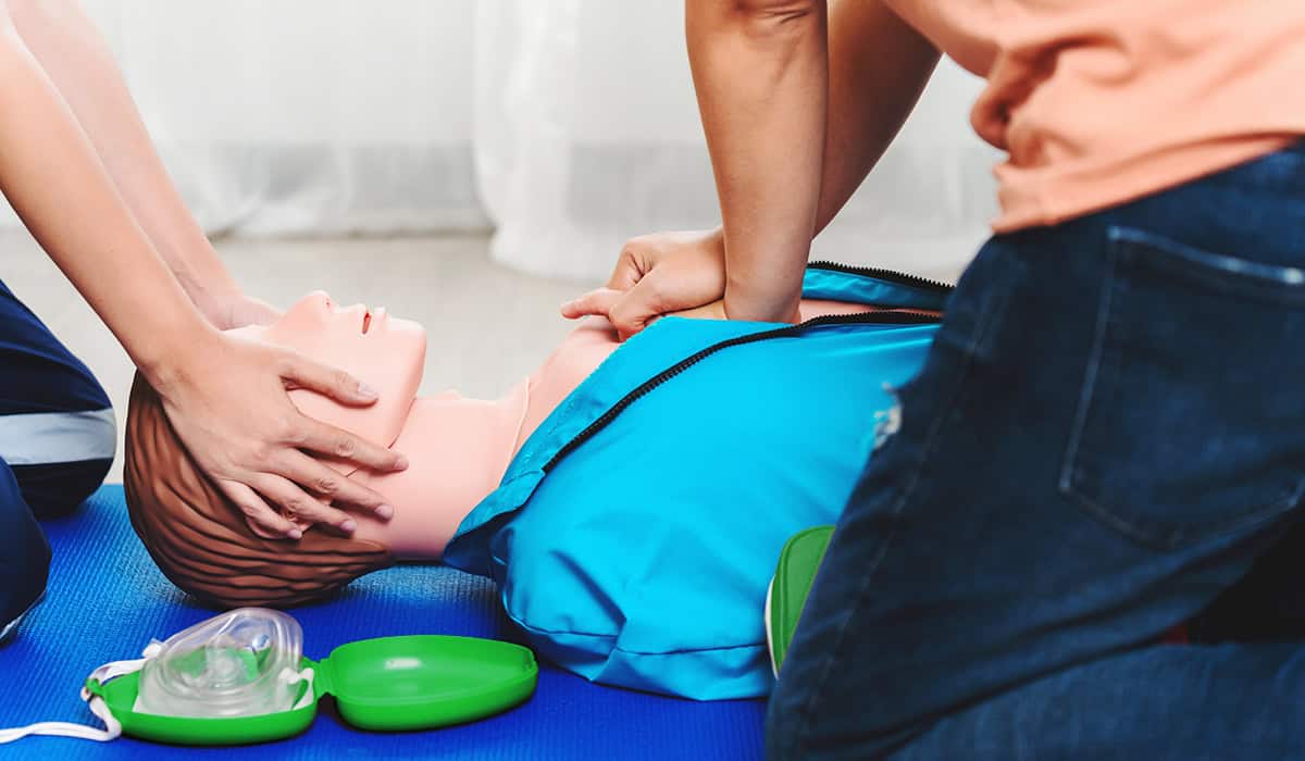 An image of someone performing CPR with a training dummy